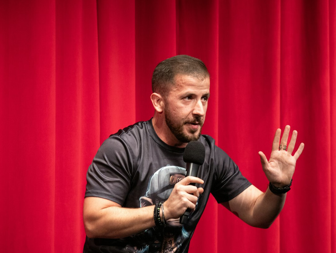 person giving speech on stage